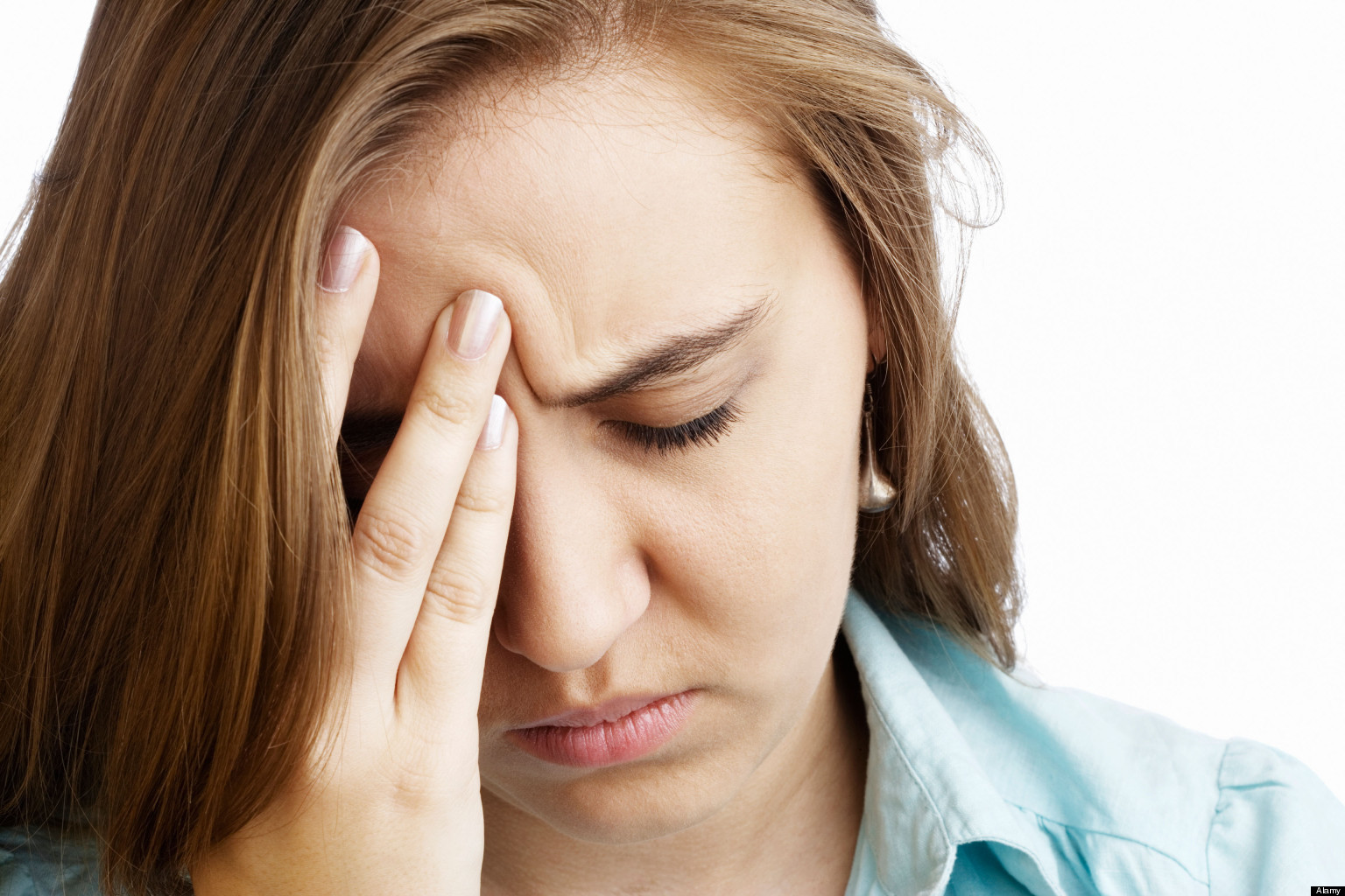Portrait of a woman holding her head with a pained expression.